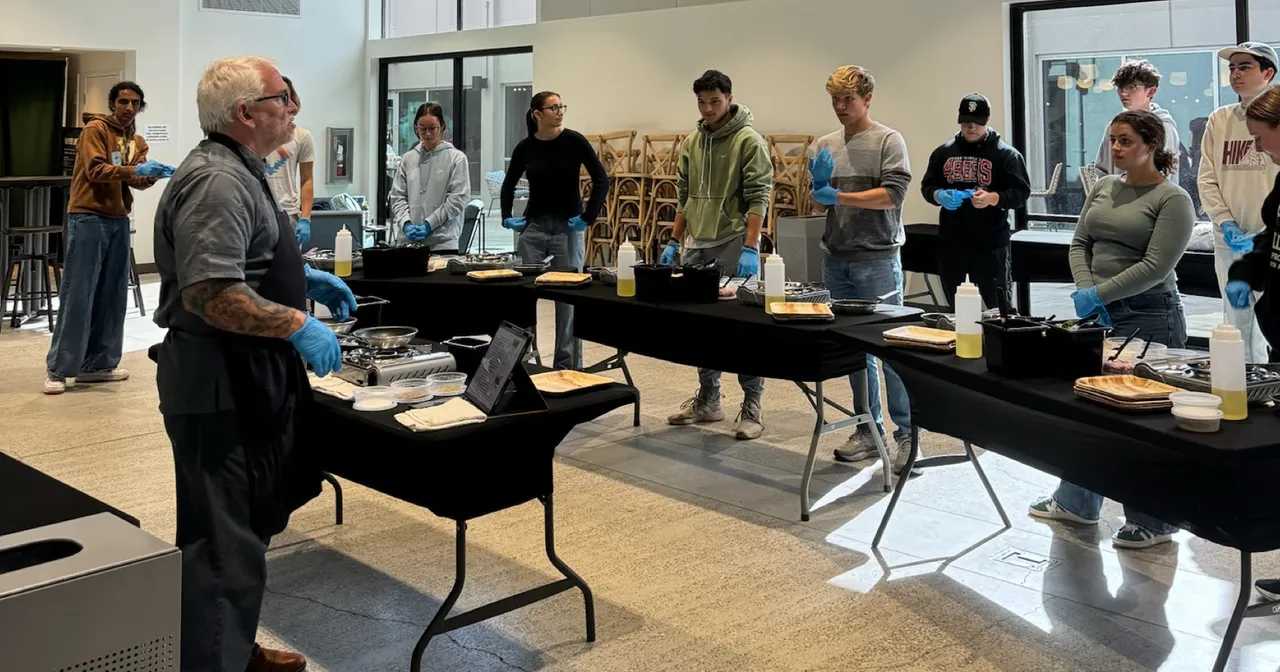 Professor teaching students culinary skills.